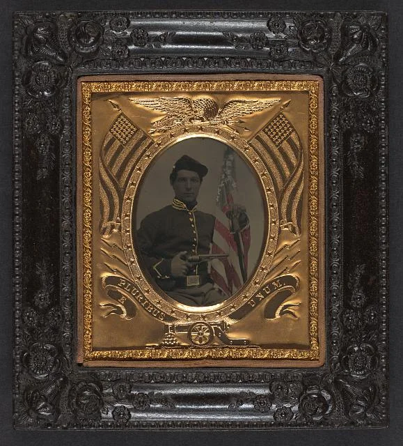 Soldier in Union Uniform with Colt Army Model 1860 Revolver, Sword, and American Flag | Circa 1861-1865