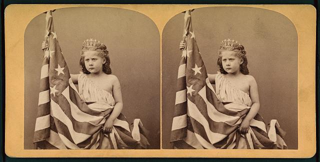 Little Girl Wearing a Gown and Crown, Unfurling an American Flag | Circa 1873