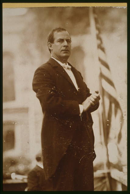 William Jennings Bryan Standing on Stage with the American Flag | Circa 1896