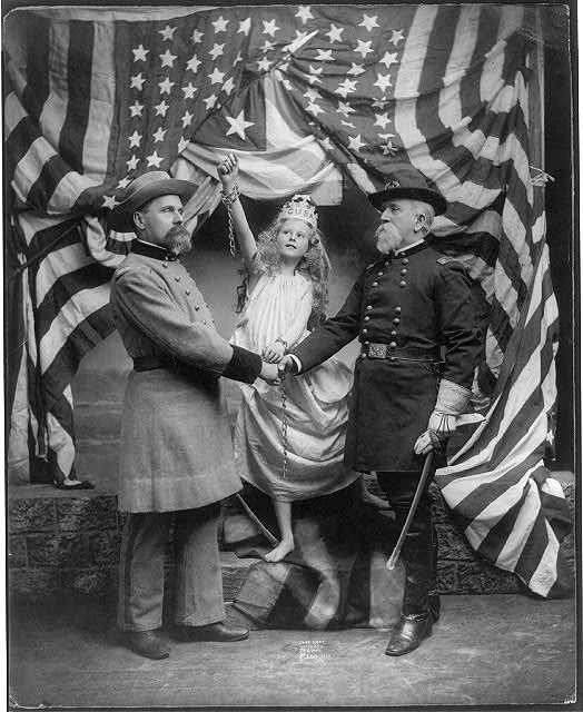Union and Confederate Soldier Shaking Hands in Front of Young Female Personification of Cuba with Broken Shackles and a Large Flag in the Background | Circa 1898