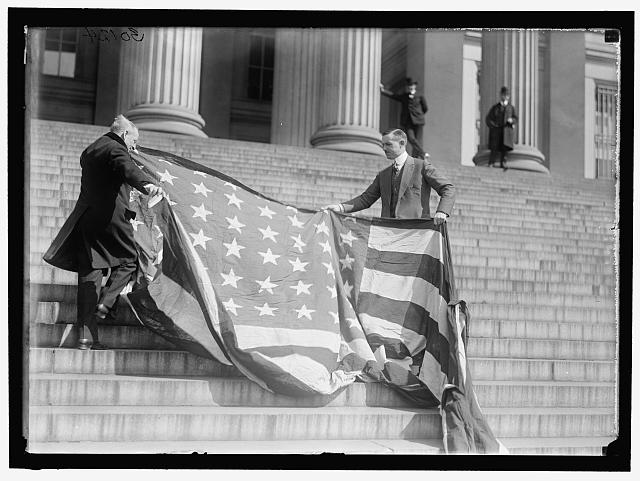 Carter Glass and F.R. Wilson with Capitol Flag on Treasury Steps | Circa 1919