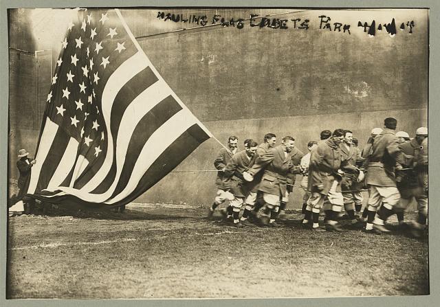 Group of Men Raising Large American Flag on Opening Day of the Baseball Season at Ebbets Field | Circa 1914