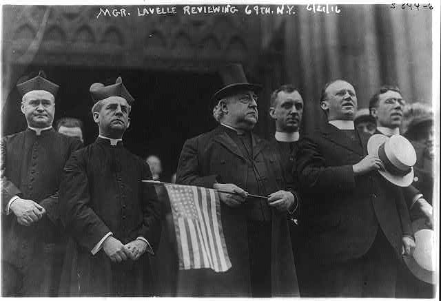 Mgr. Lavelle Holding U.S. Flag | Circa 1916