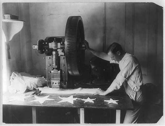 Man Cutting Out Stars with a Machine | Circa 1900