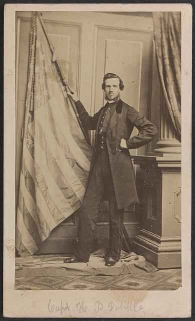 Harry B. Doolittle of Co. C, 2nd Iowa Infantry Regiment, Holding Regimental Flag and Standing on First National Flag of the Confederacy | Circa 1861-1863