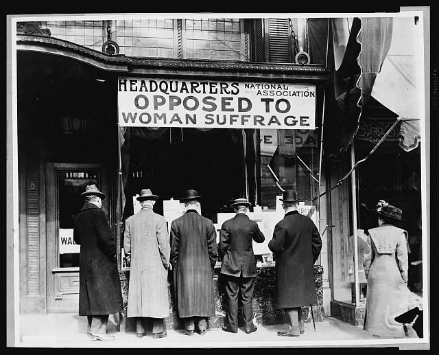 Men Looking at Material Posted in the Window of the National Anti-Suffrage Association Headquarters | Circa 1911