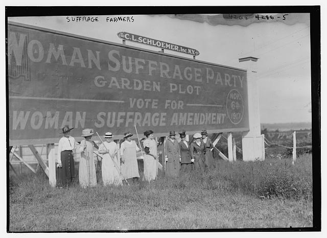 Suffragettes Standing in Front of a Billboard Supporting the Woman Suffrage Amendment | Circa 1917