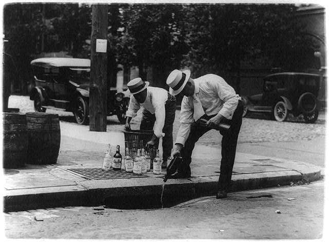 Pouring Whiskey into a Sewer | Circa 1909