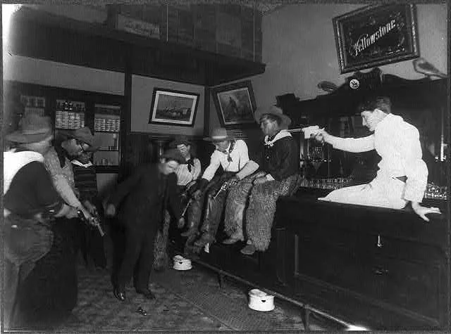 Seven Men in a Saloon Shooting Down at the Floor Forcing Another Man to Dance | Circa 1907