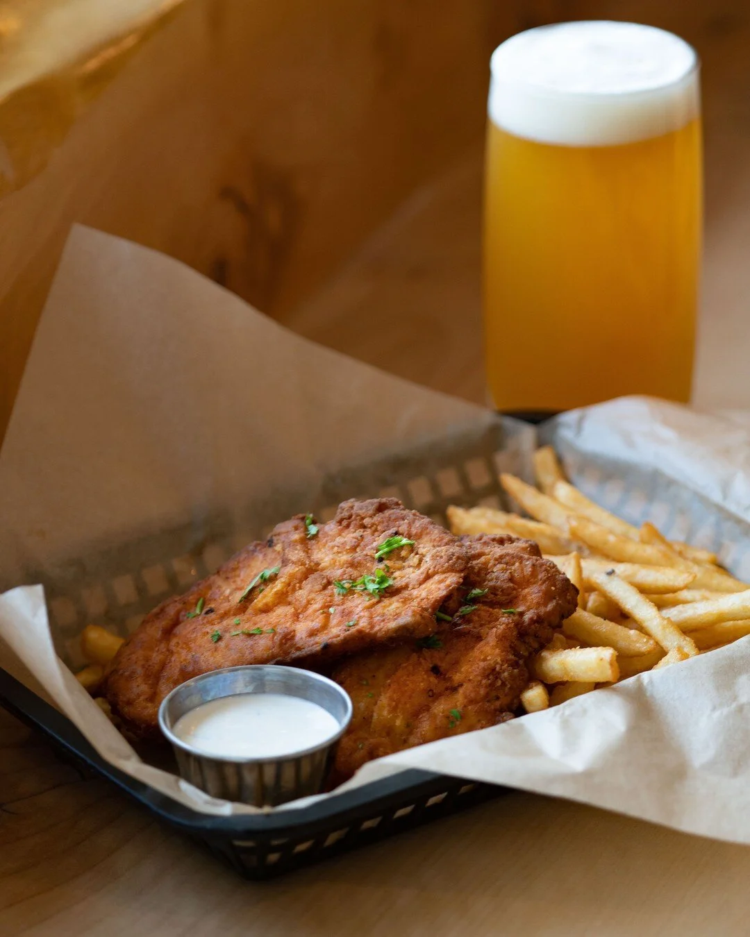 A Saturday classic to have on a mild summer day at the Downtown Pub! Our hand-breaded Chicken Tenders are offered with our famous beer-battered fries and your choice of house dipping sauce. Pair it perfectly with a fresh Animal Cookies IPA for the ul