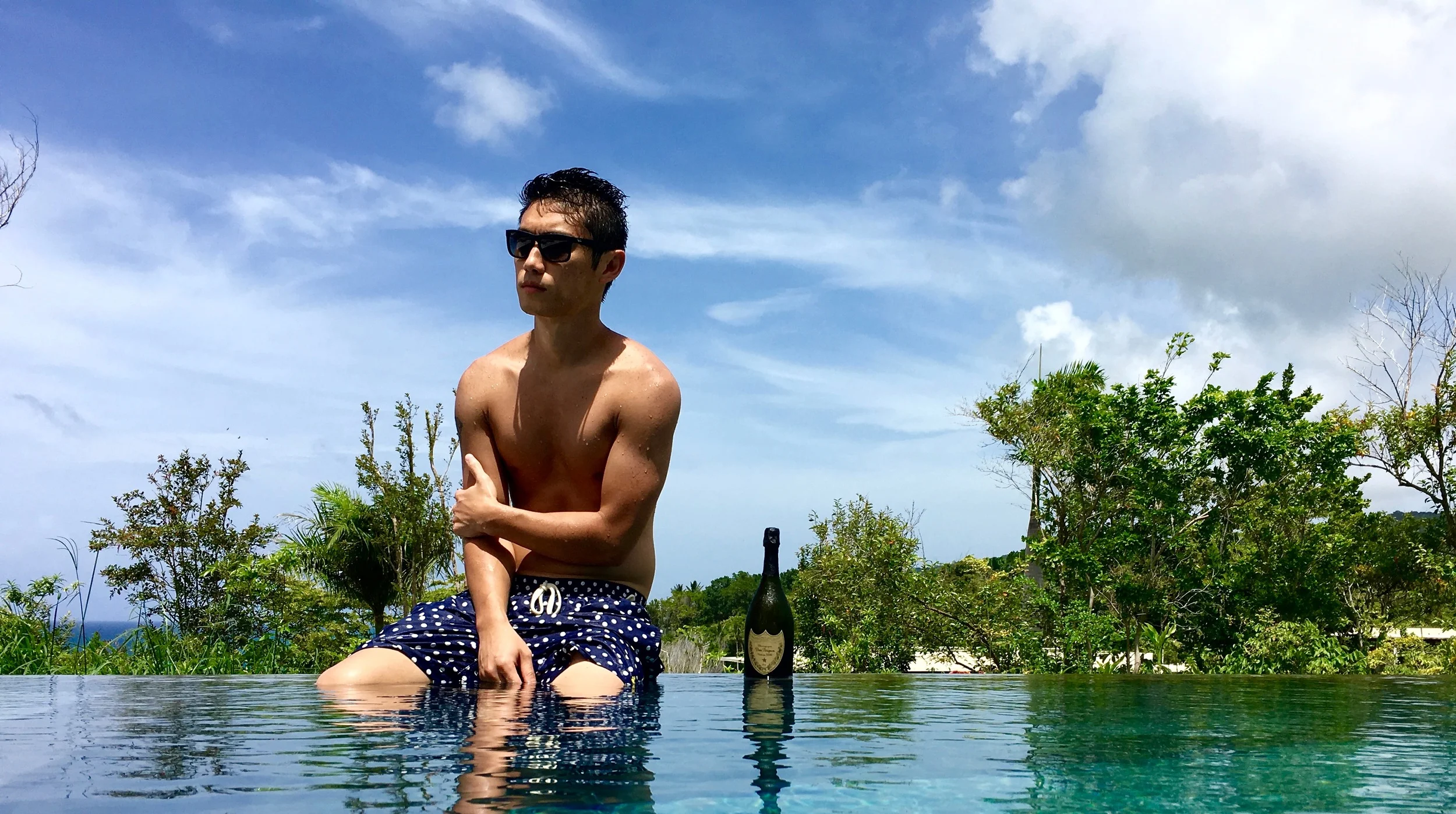 In our pool, pondering ways to extend our stay...