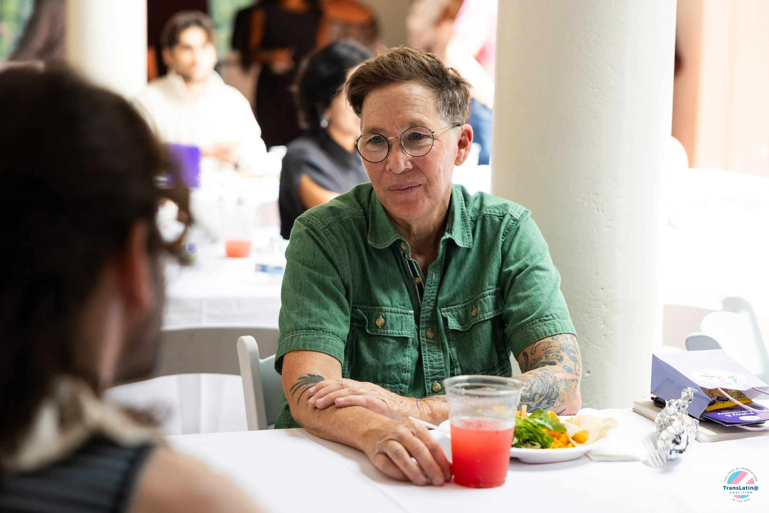 An attendee participates in a table conversation during the Trans Pláticas report release.