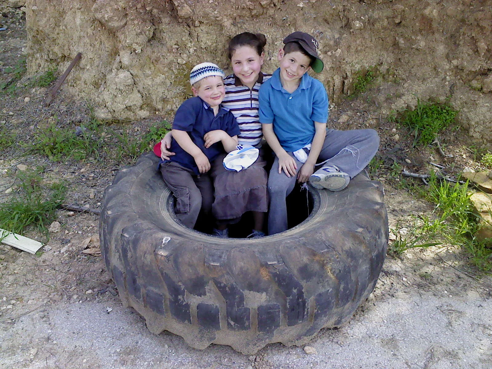 3 Kids in Tractor Tire-773417.JPG