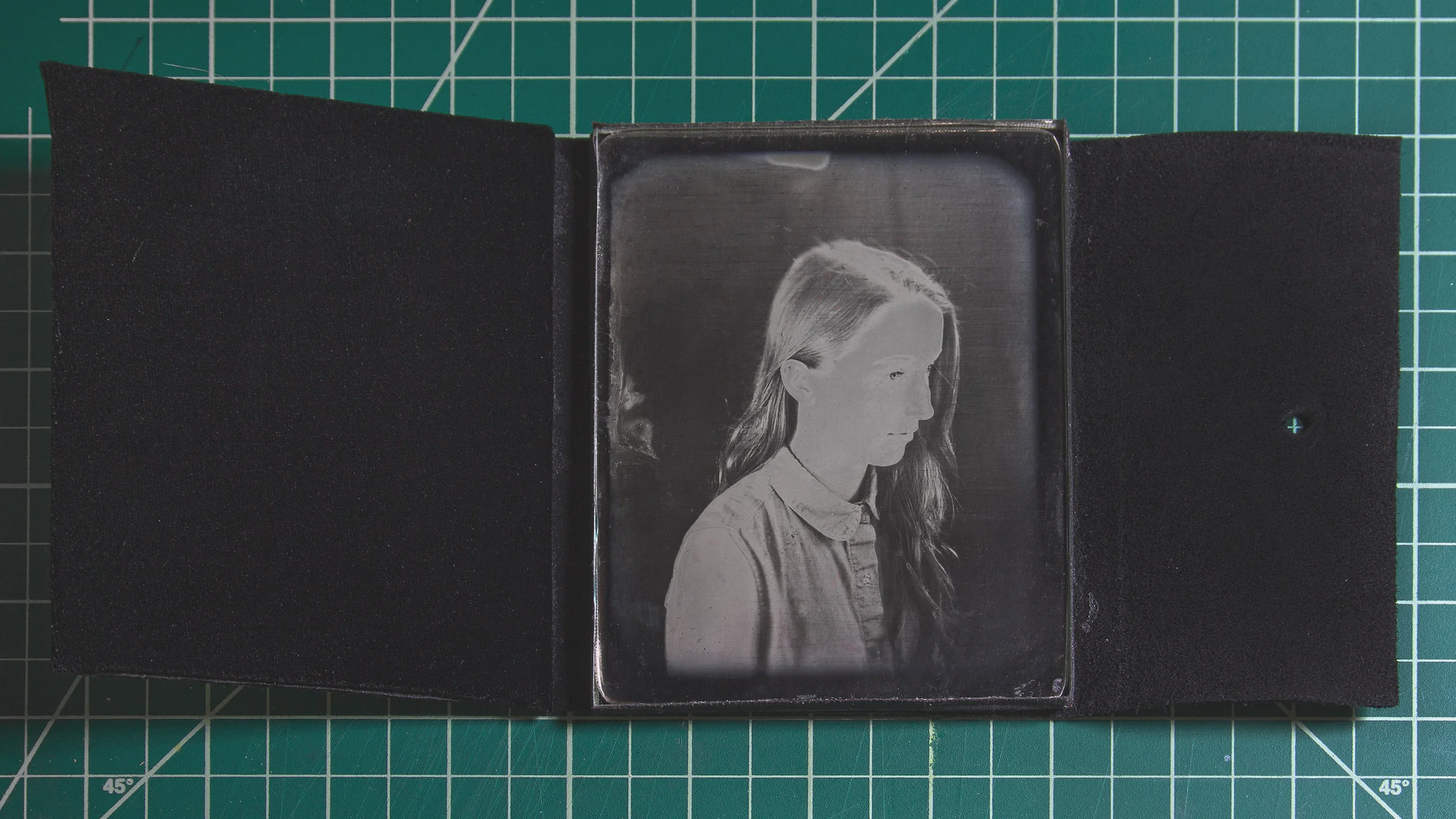 A contemporary Daguerreotype in a suede case with a velvet vieweing pad.