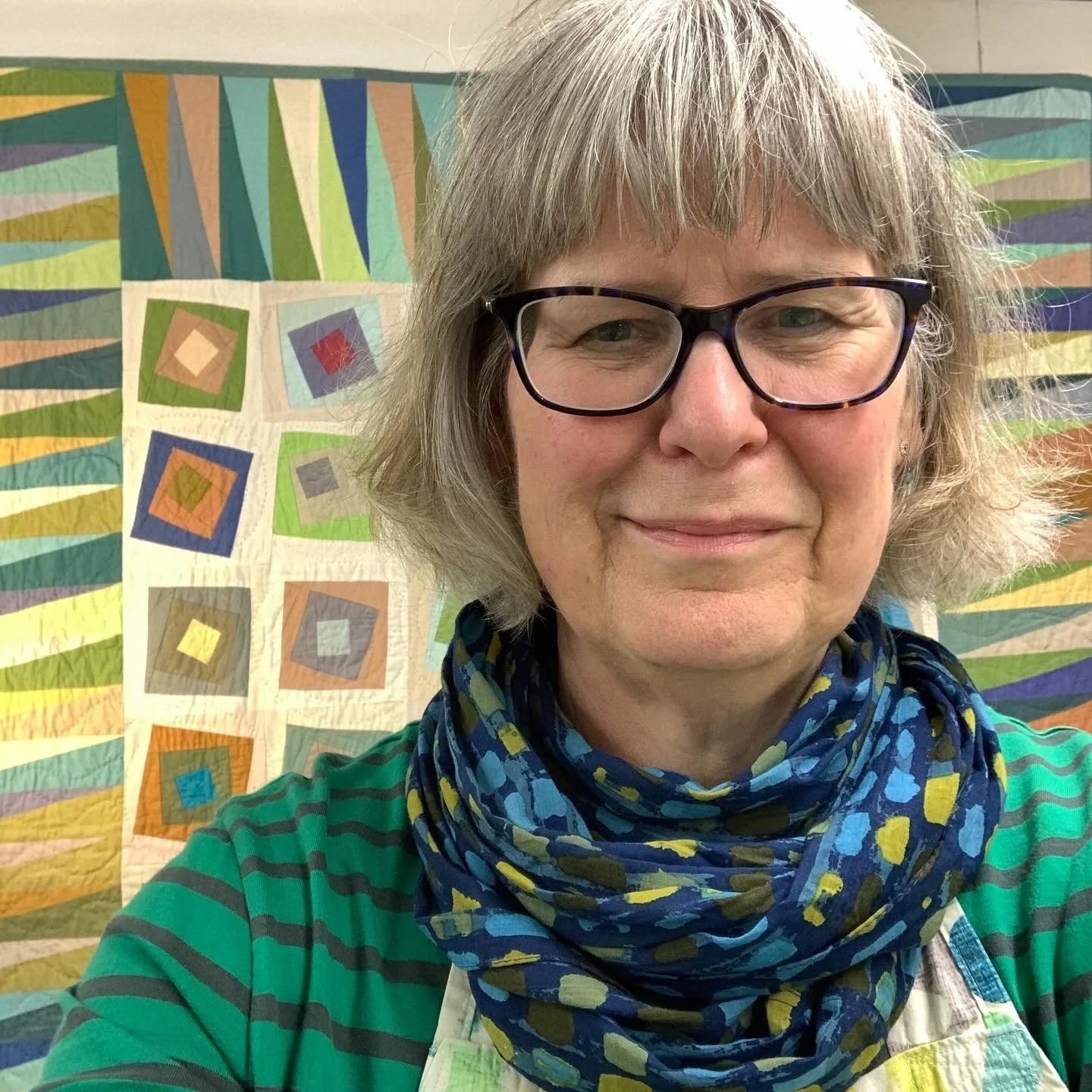 Question - are you turning into your quilts? Late night snap (hence the tired-eyed, no lipstick-left-look) as I was tidying up after class and I realise that I tone beautifully with my quilt, Jumeirah I, which is currently #quiltonmywall in the workr
