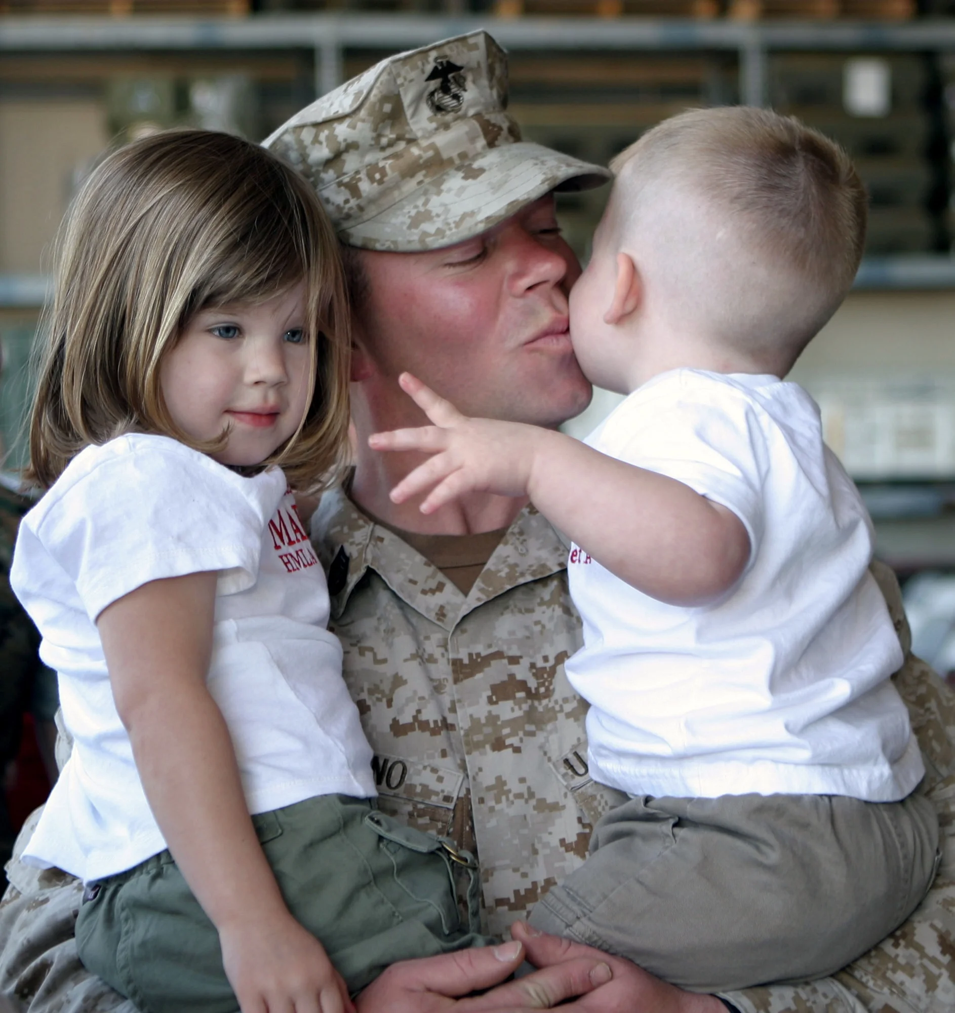 soldier kissing kids.jpg