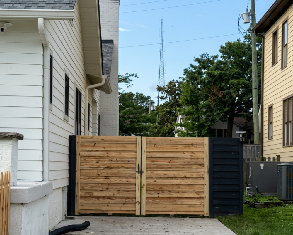 Custom horizontal wood privacy fence gate installed by K&C Fence between two homes in Nashville, Tennessee, creating a secure and modern outdoor living space.