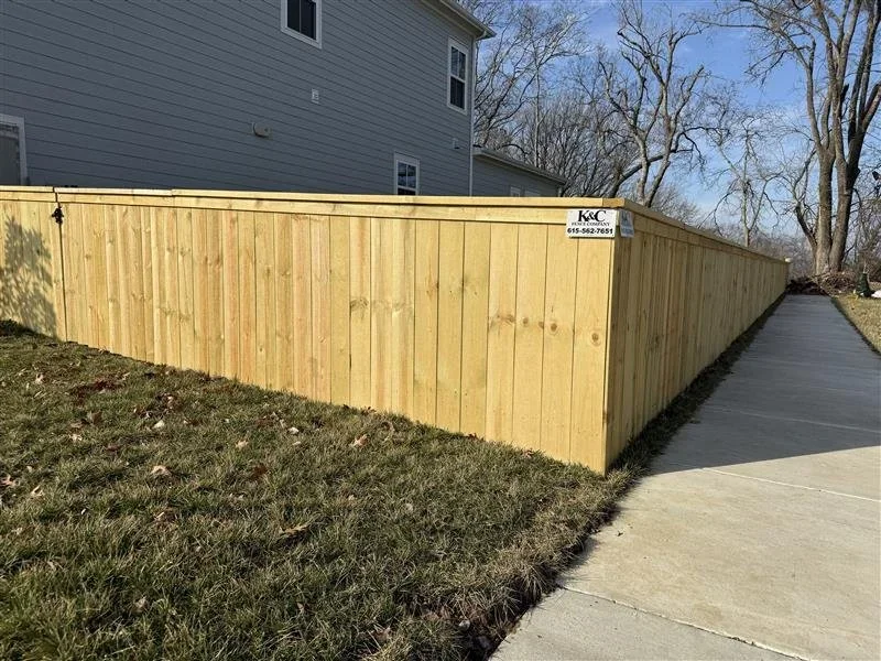 K&C Fence table top wood privacy fence beside a home and sidewalk in Franklin, Tennessee.