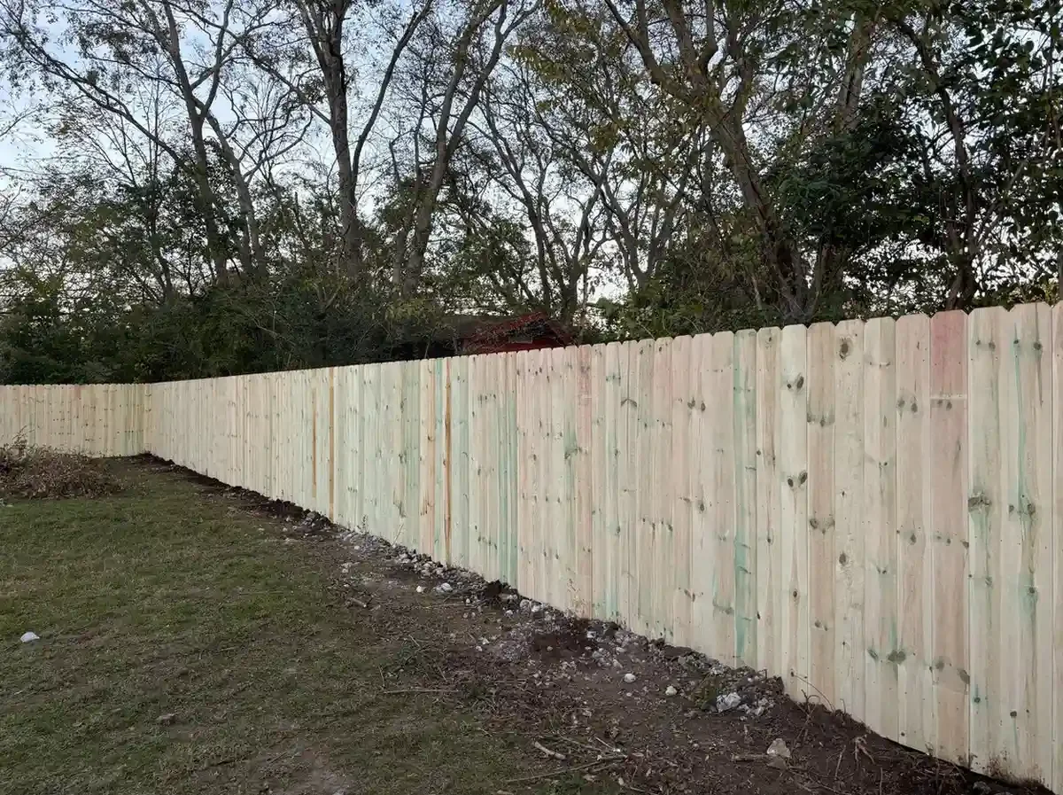 K&C Fence dog-eared wood privacy fence bordering a wooded backyard in Madison, Tennessee.