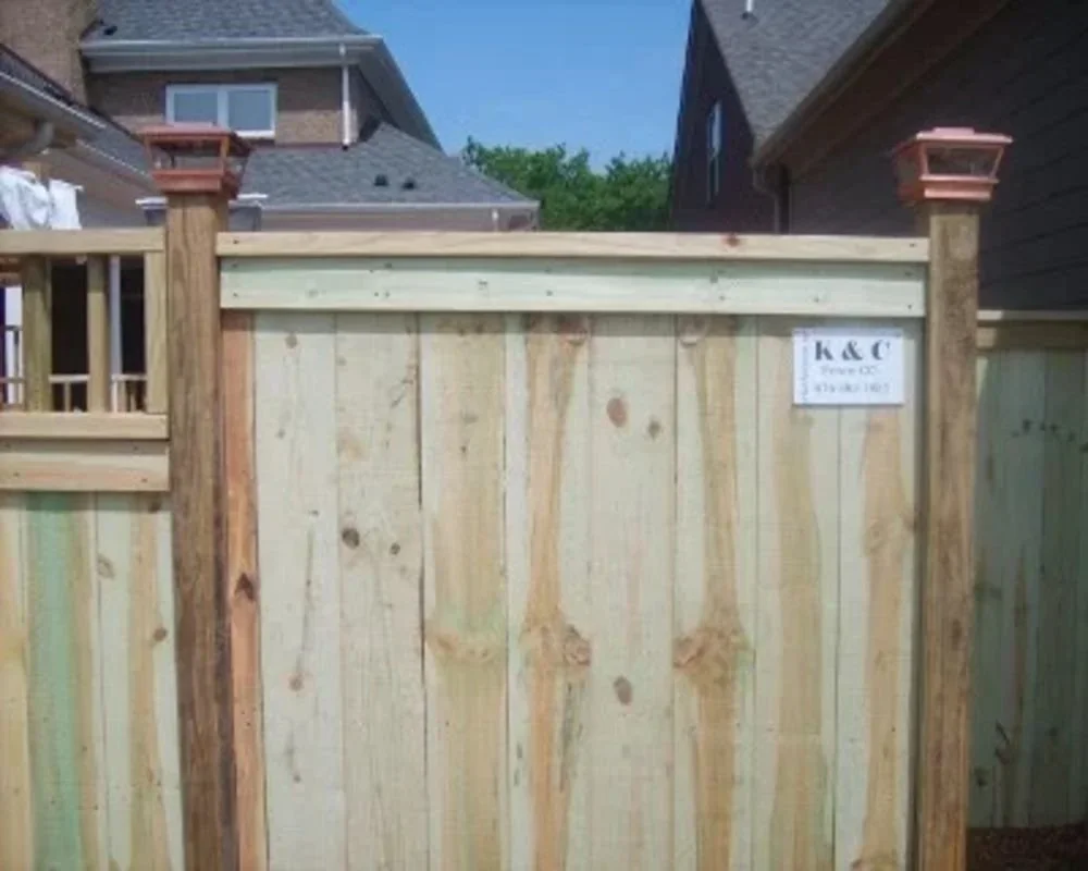 K&C Fence wood privacy fence with solar post caps between homes in Nashville, Tennessee.