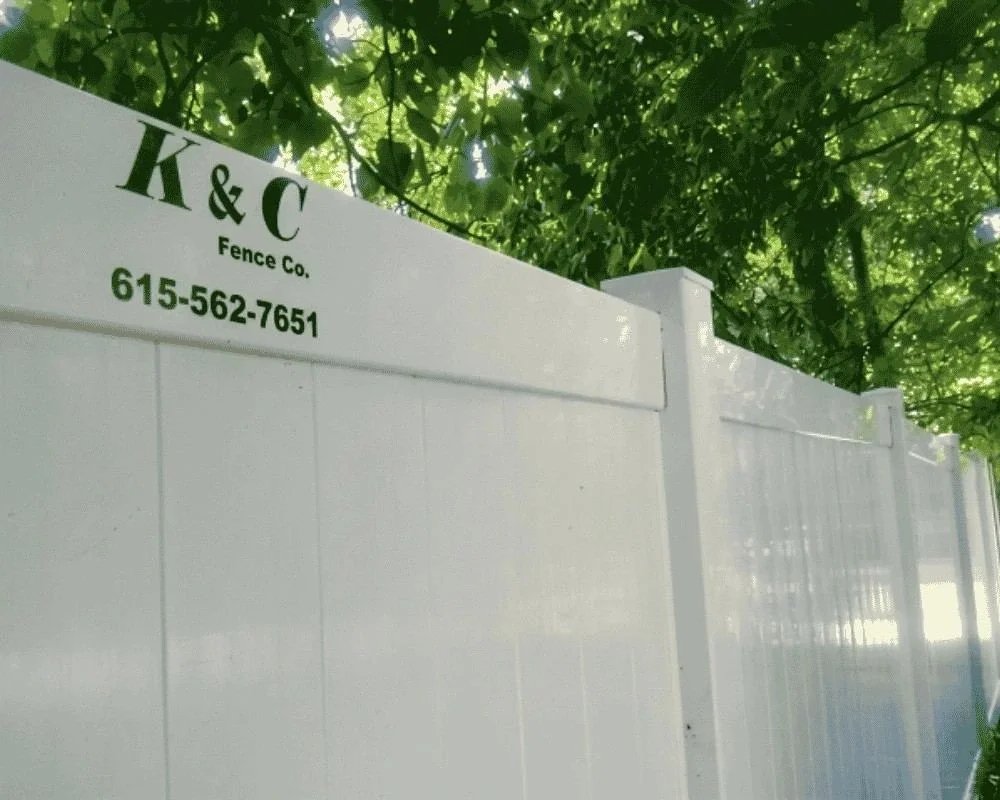 White PVC vinyl privacy fence by K&C Fence under mature trees in Nashville, Tennessee.