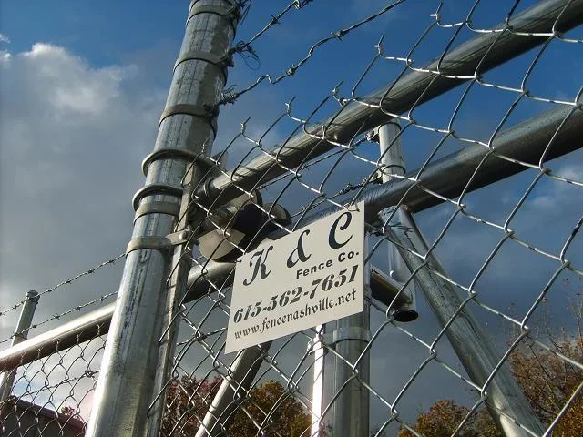 K&C Fence commercial chain-link security fence with barbed wire at a property in Nashville, Tennessee.
