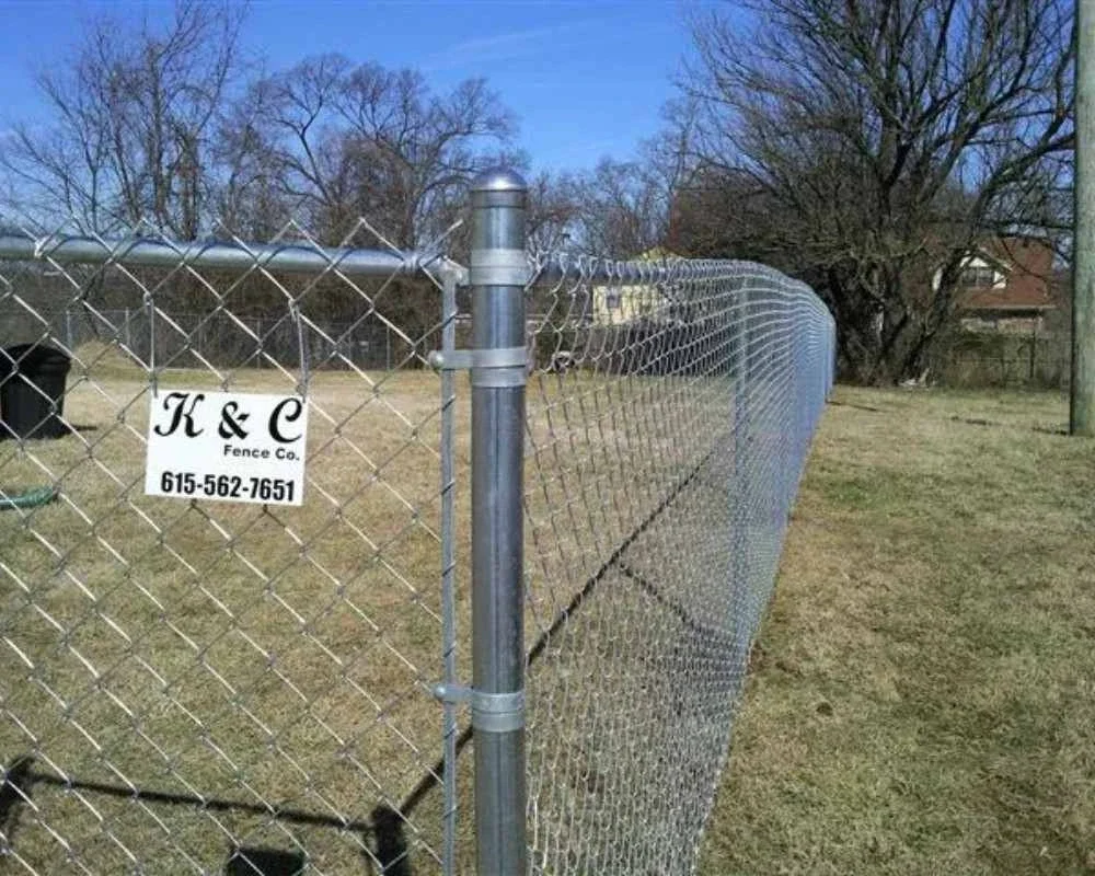 K&C Fence four-foot galvanized chain-link fence enclosing an open property in Nashville, Tennessee.