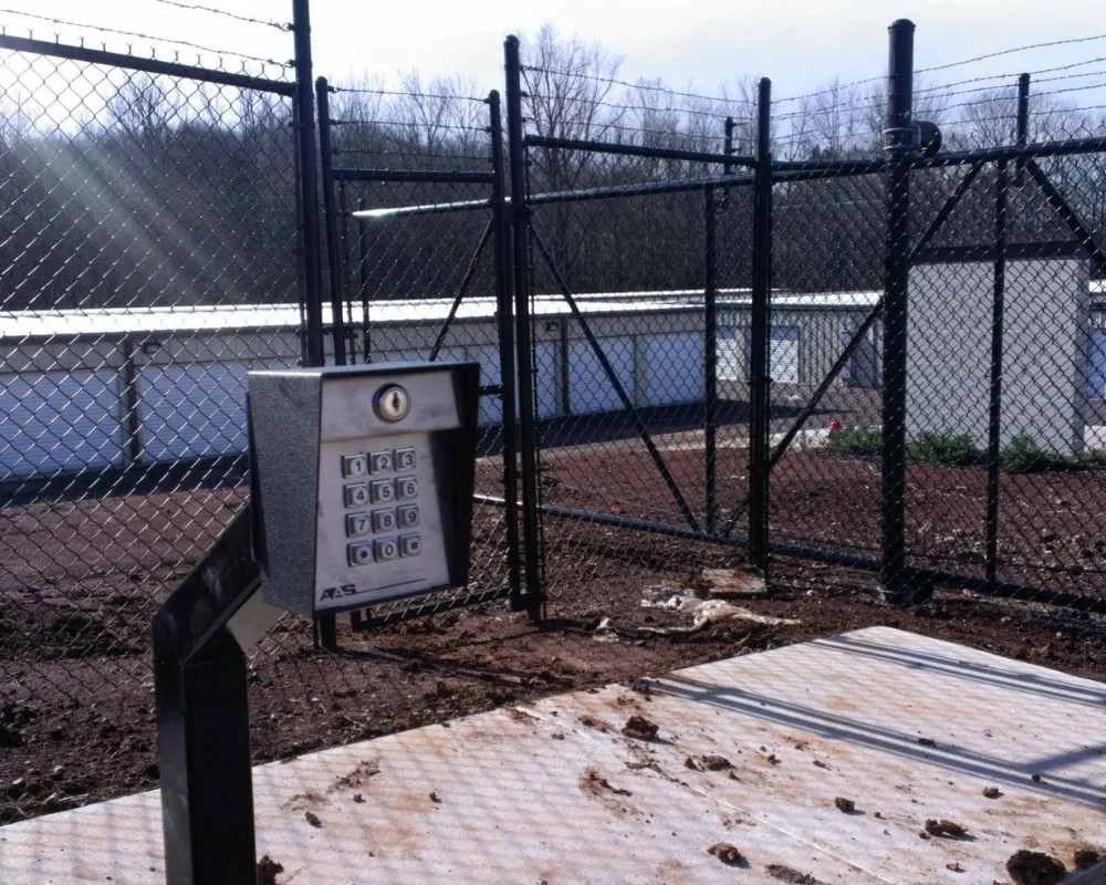 K&C Fence black vinyl chain-link gate with keypad access secures a commercial storage facility in Nashville, Tennessee.