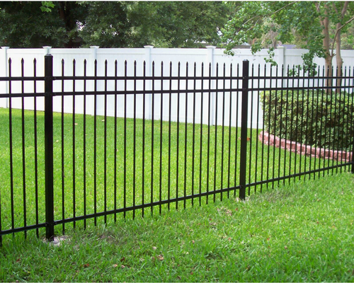K&C Fence black aluminum ornamental fence runs along a bright green backyard with a white vinyl privacy fence in the background in Lebanon, Tennessee.