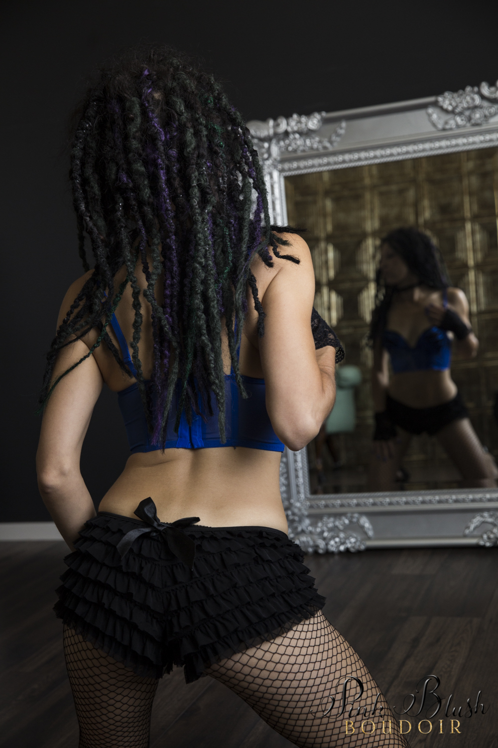 Boudoir Photography Edmonton, woman kneeling in front of a mirror with dred locks
