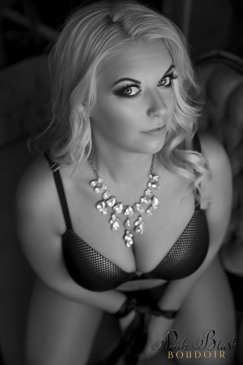 boudoir Edmonton, a woman looking at camera in a bra and panty set with her hands tied up