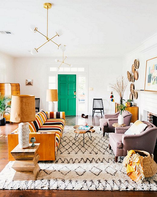 Vintage vibes abound, using complimentary vintage pieces and poppy bright colors (such as on the door) can be party in the front and business in the back. We love how these vintage pieces mesh so well with the new ones! That rug really pulls everything together also by adding playful texture. ( source )