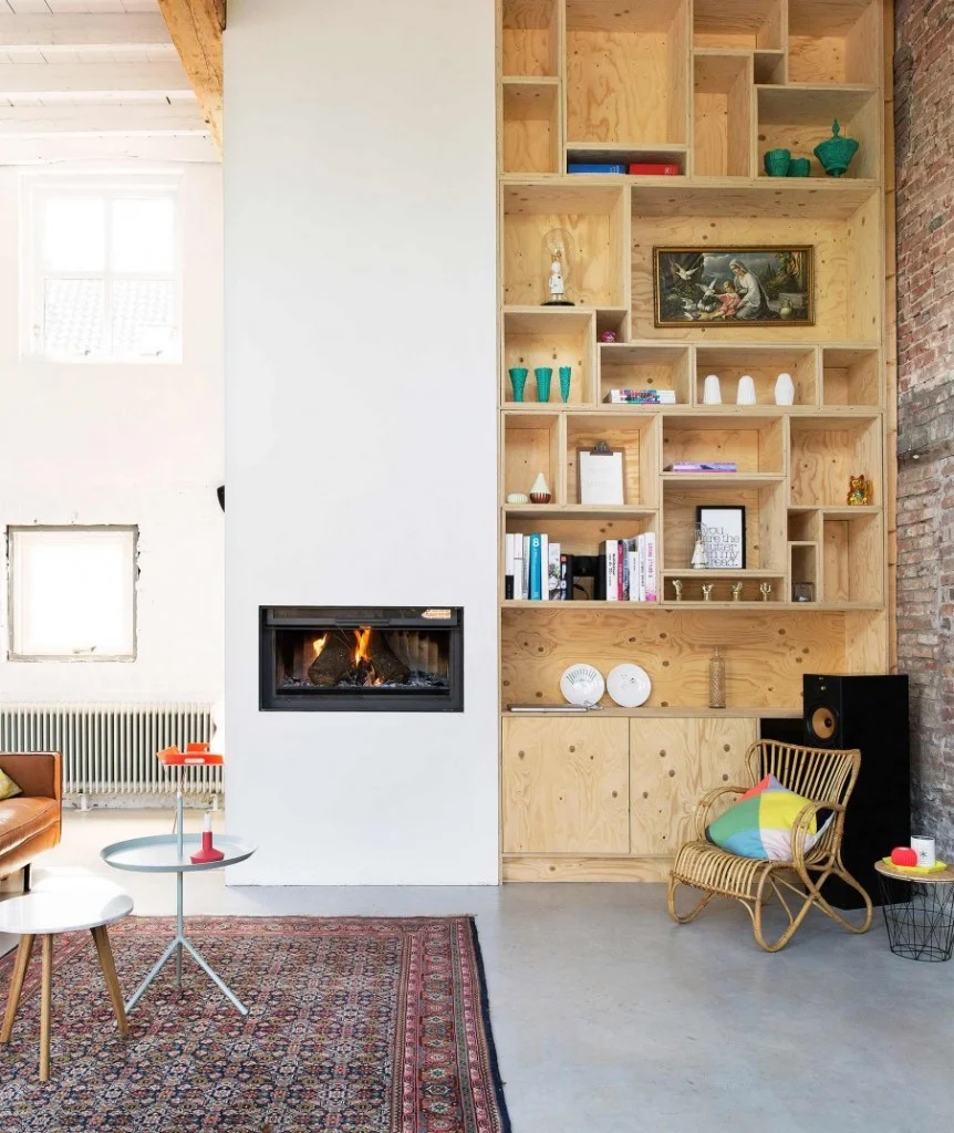 The pops of color here and wood texture are phenomenal and make the room seem cozy despite its size. ( source )