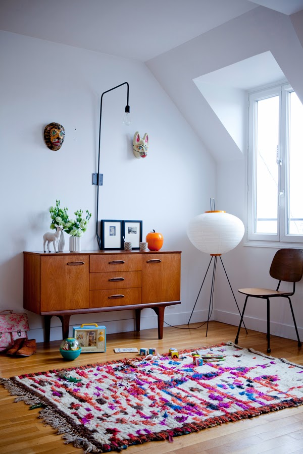 Bright colors work well against wood furnishings and white walls while not appearing overly cluttered or ambiguous. ( source)
