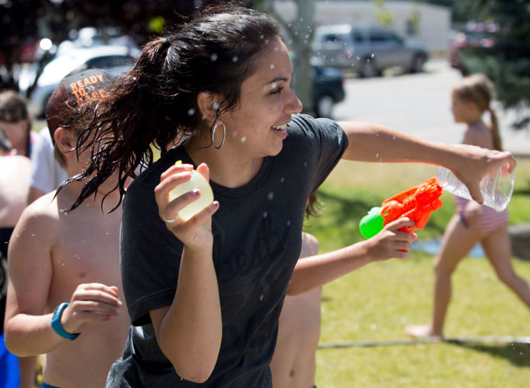 KATIE HARTWIG/CDA Press - Nica Guinasso, age 19, of Coeur d'Alene enjoys times with the kids on water day at the Boys and Girls club in Post Falls, Friday. Guinasso is one of the 24 Americorps volunteers this summer.
