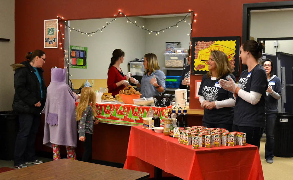 Volunteers help out at the holiday event.
