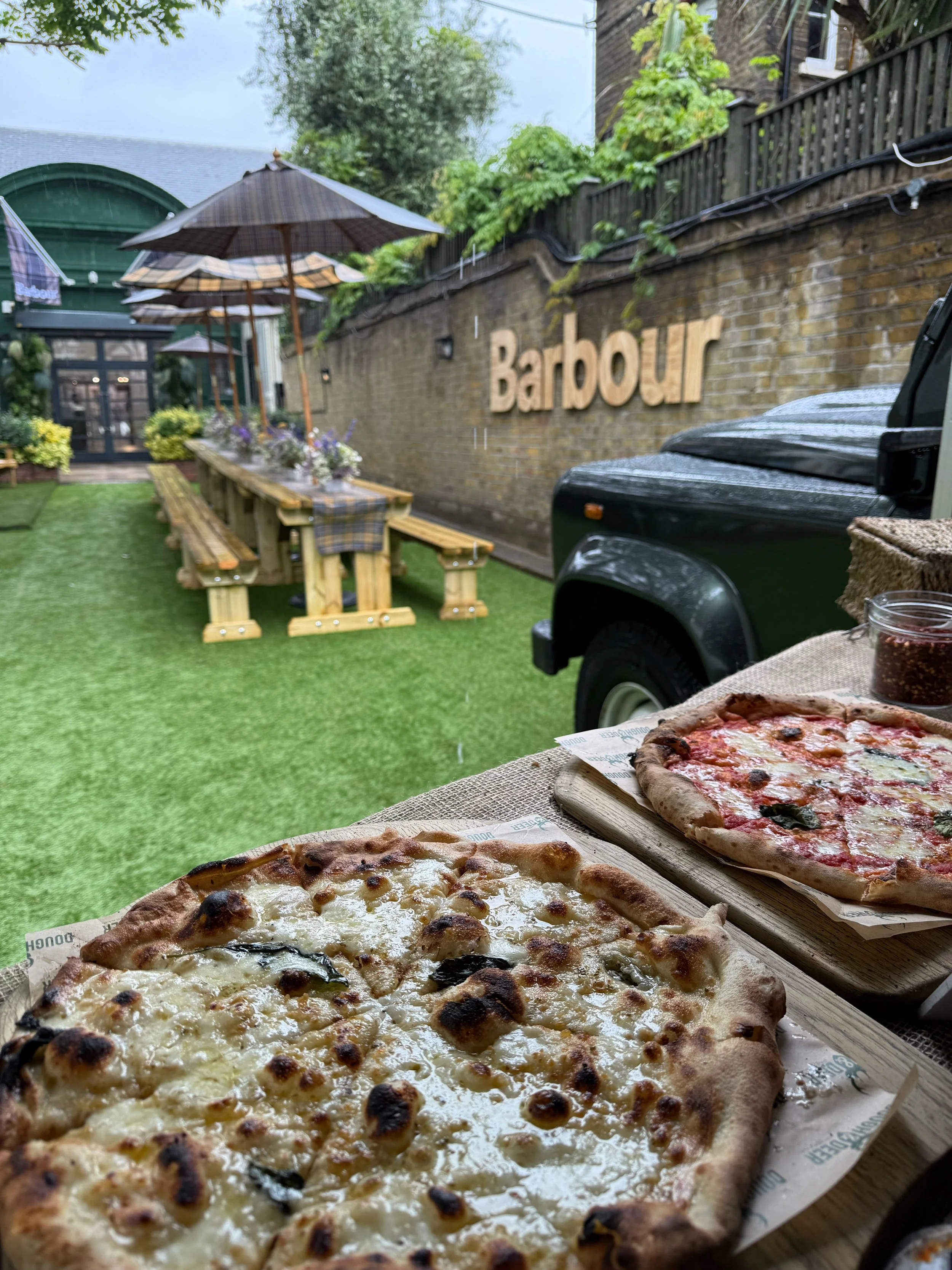 An image of a premium catering van serving pizzas at a corporate event in London for the clothes brand Barbour