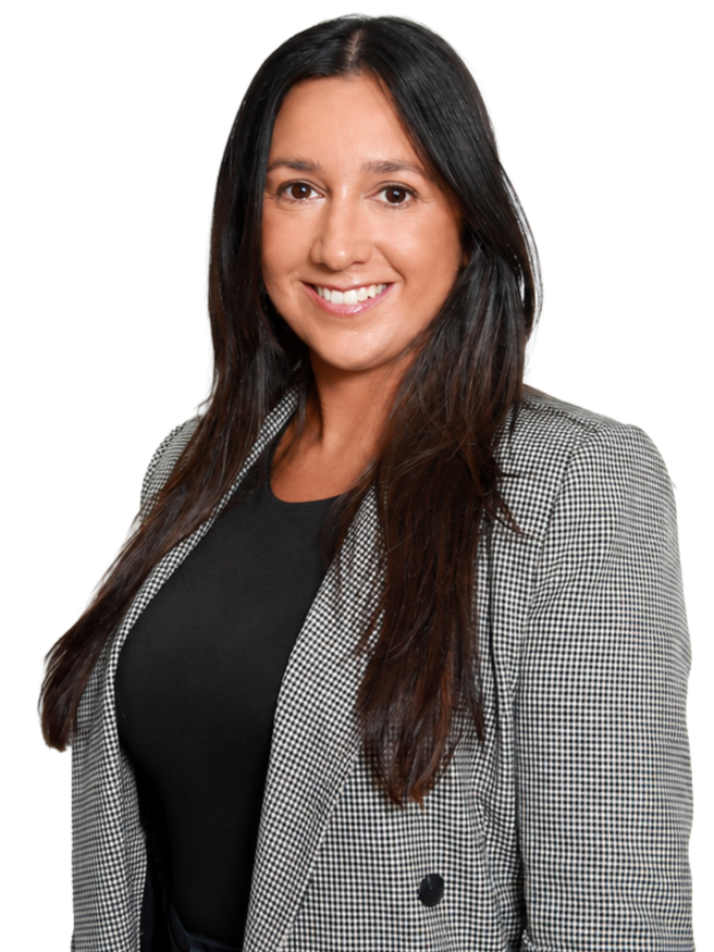A smiling woman with long dark hair wearing a black top and a checkered blazer.