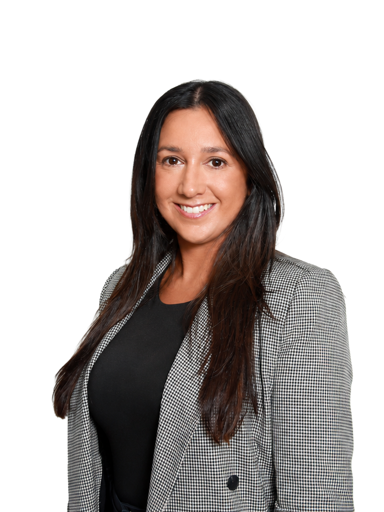 A woman with long dark hair, smiling, wearing a black top and a gray checkered blazer.