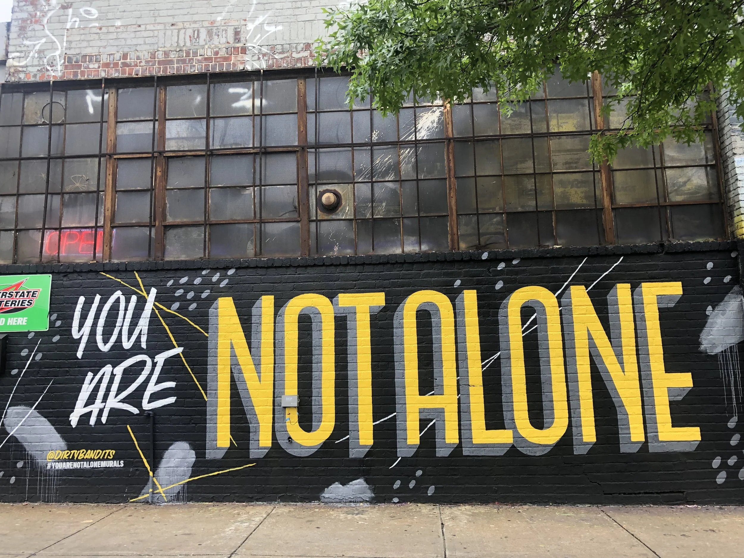 You Are Not Alone mural in Greenpoint, Brooklyn by Dirty Bandits.