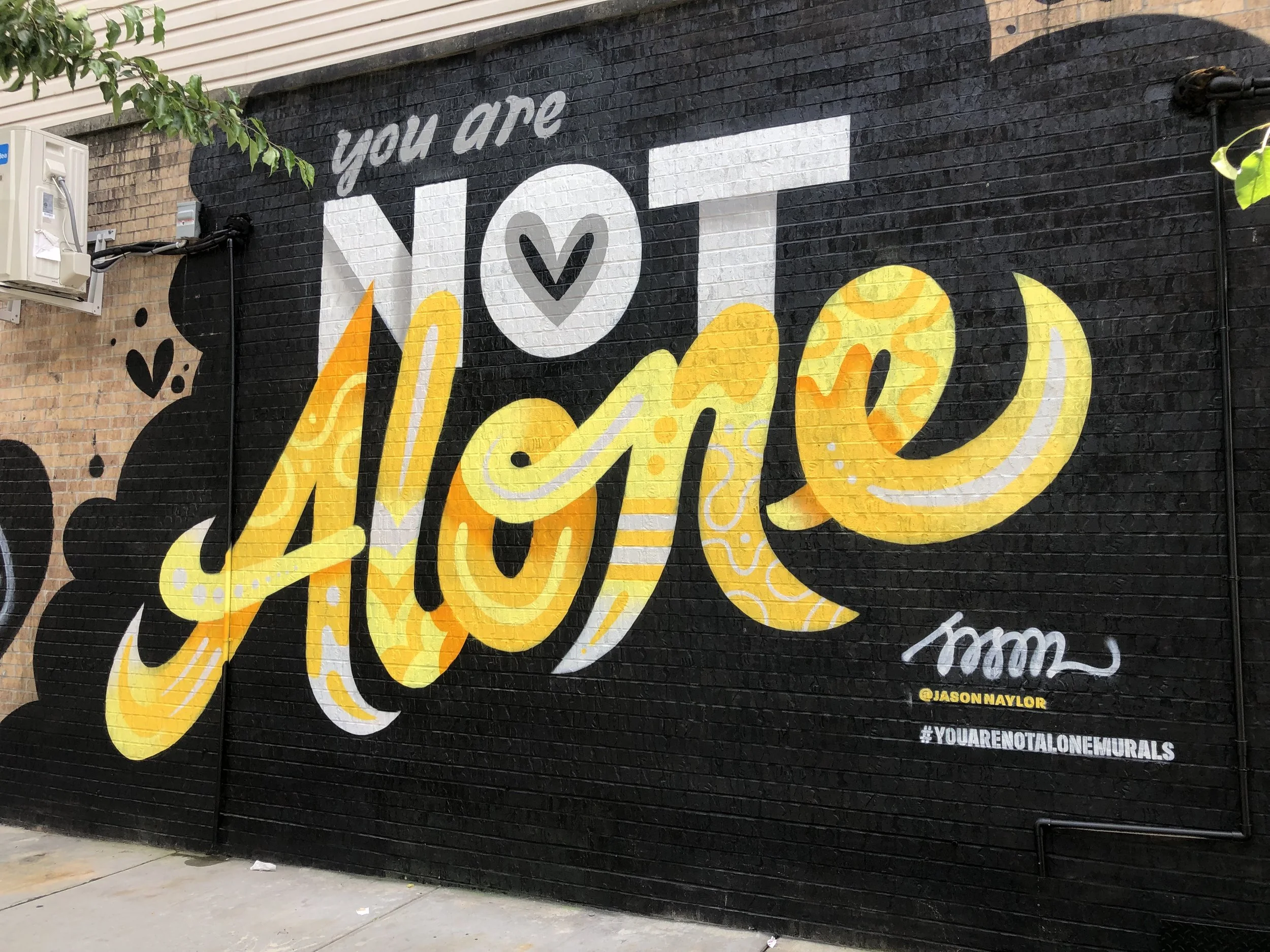 You Are Not Alone mural by Jason Naylor in Bushwick.