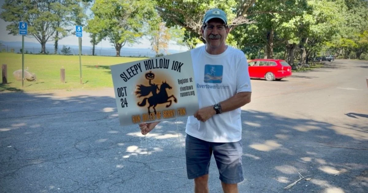 Todd Ruppel and Sleepy Hollow 10K sign for the race