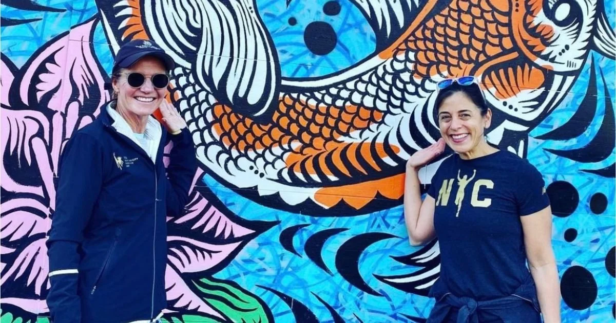 two women NYC Marathon runners in front of a mural
