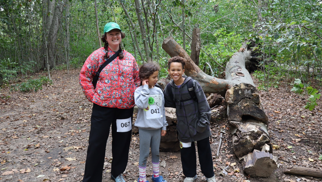 smiling woman and two kids on trail at Forest Park Queens 5K