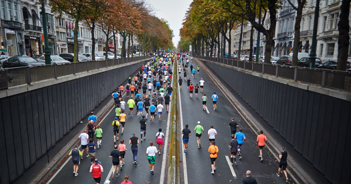 runners in city street running a 5k race