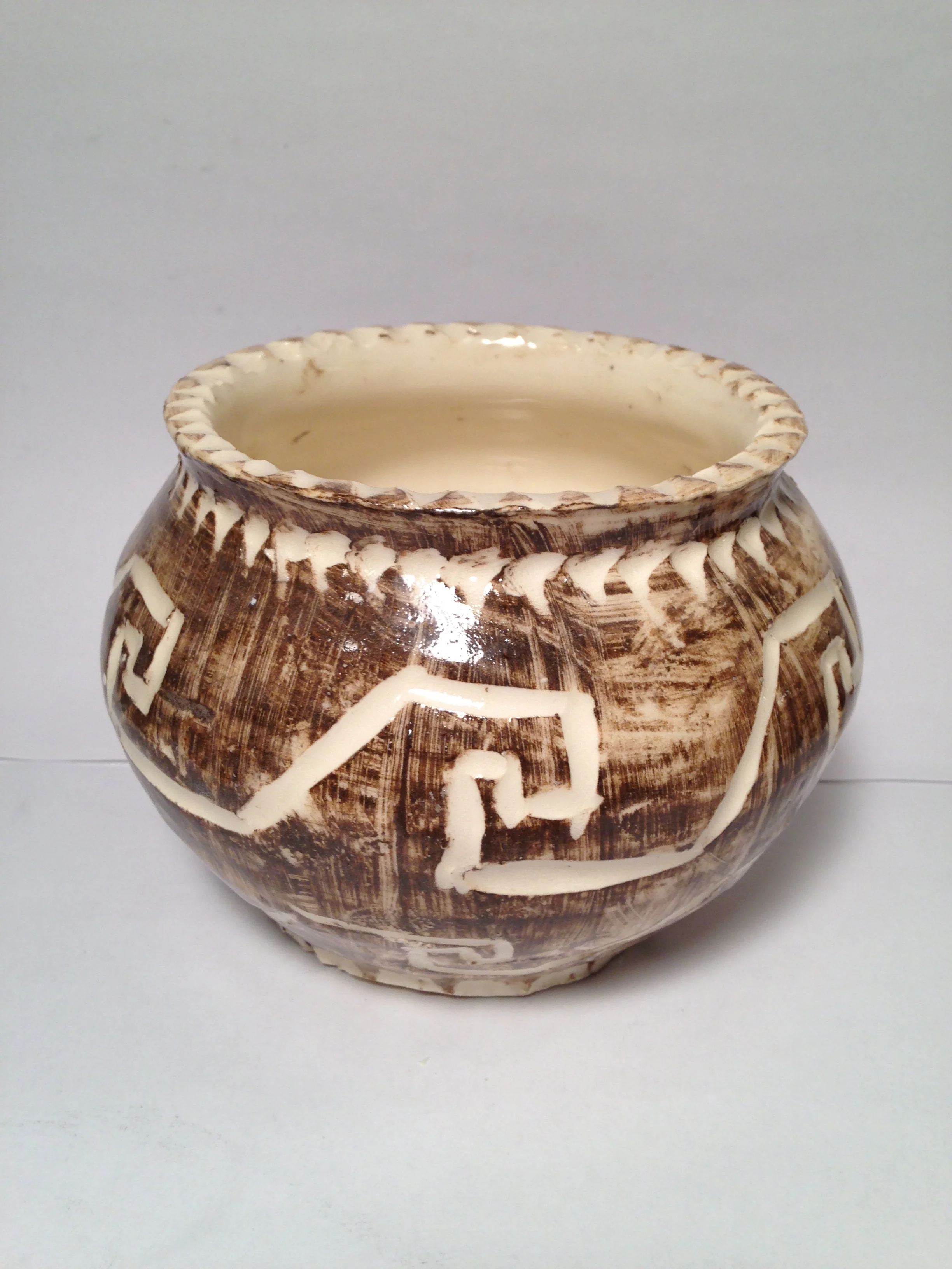 Pot with geometric and wave patterns
