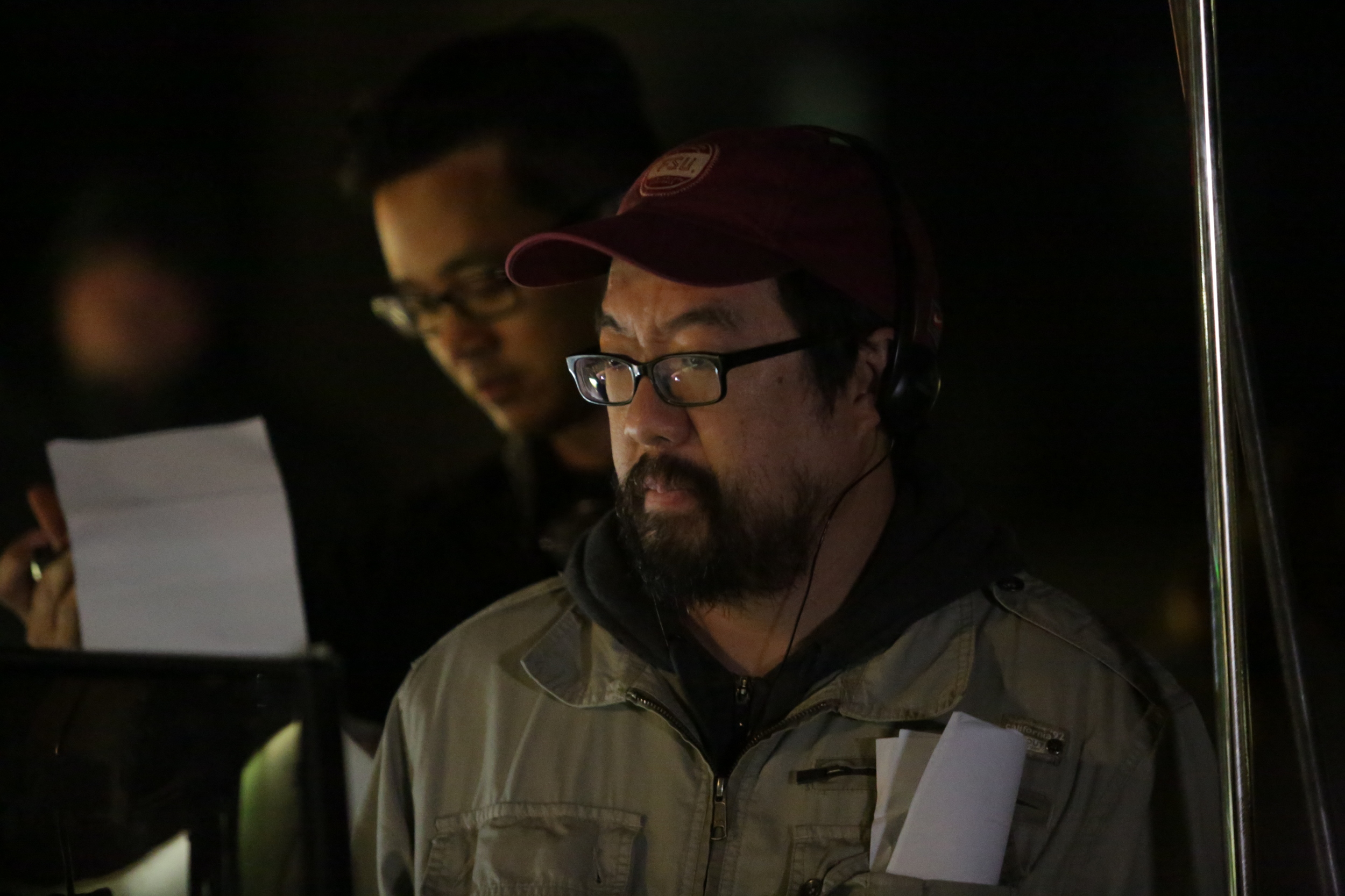 Comfort director William Lu watches a scene on the monitor. Image courtesy of Late to the Party Productions.