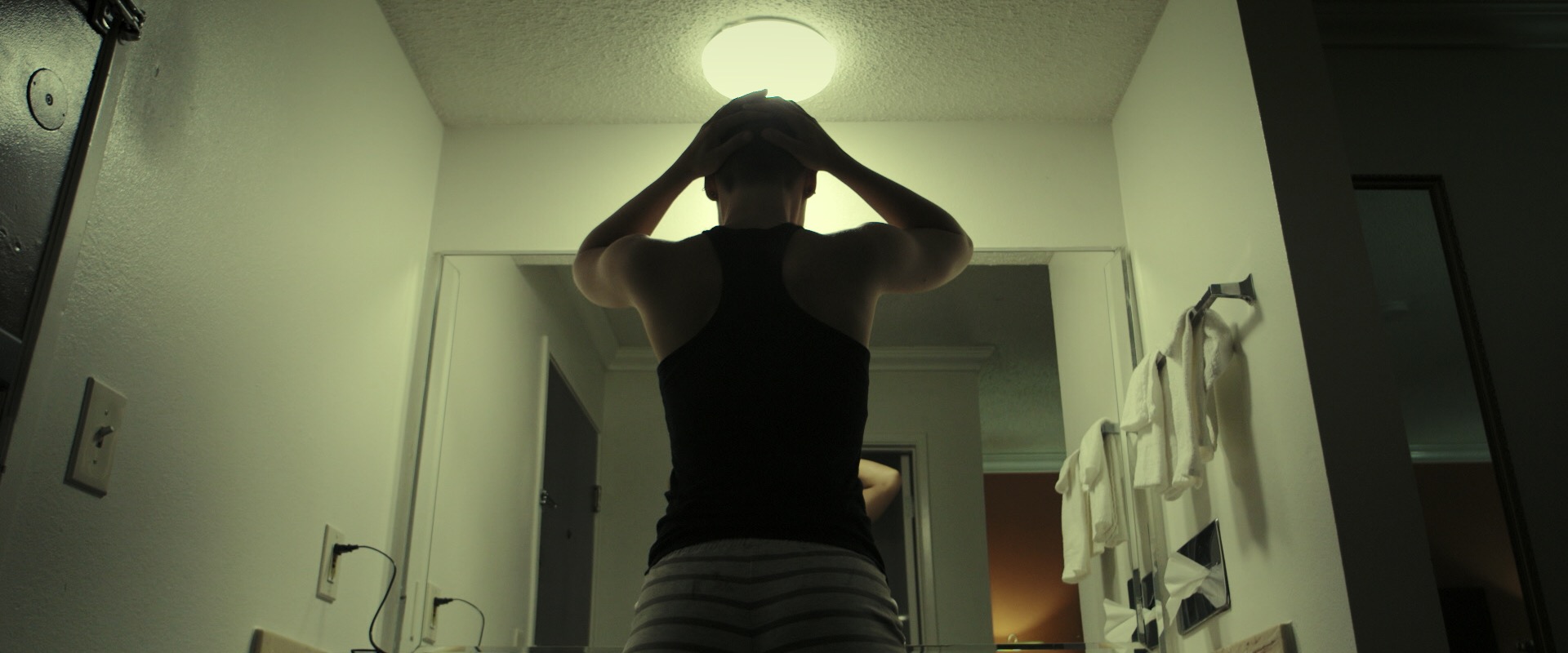 Actress Kailena Mai shaved her head for the role, showing some true dedication to the craft of filmmaking. This image represents the theme of being hidden, not really knowing who anyone truly is. 