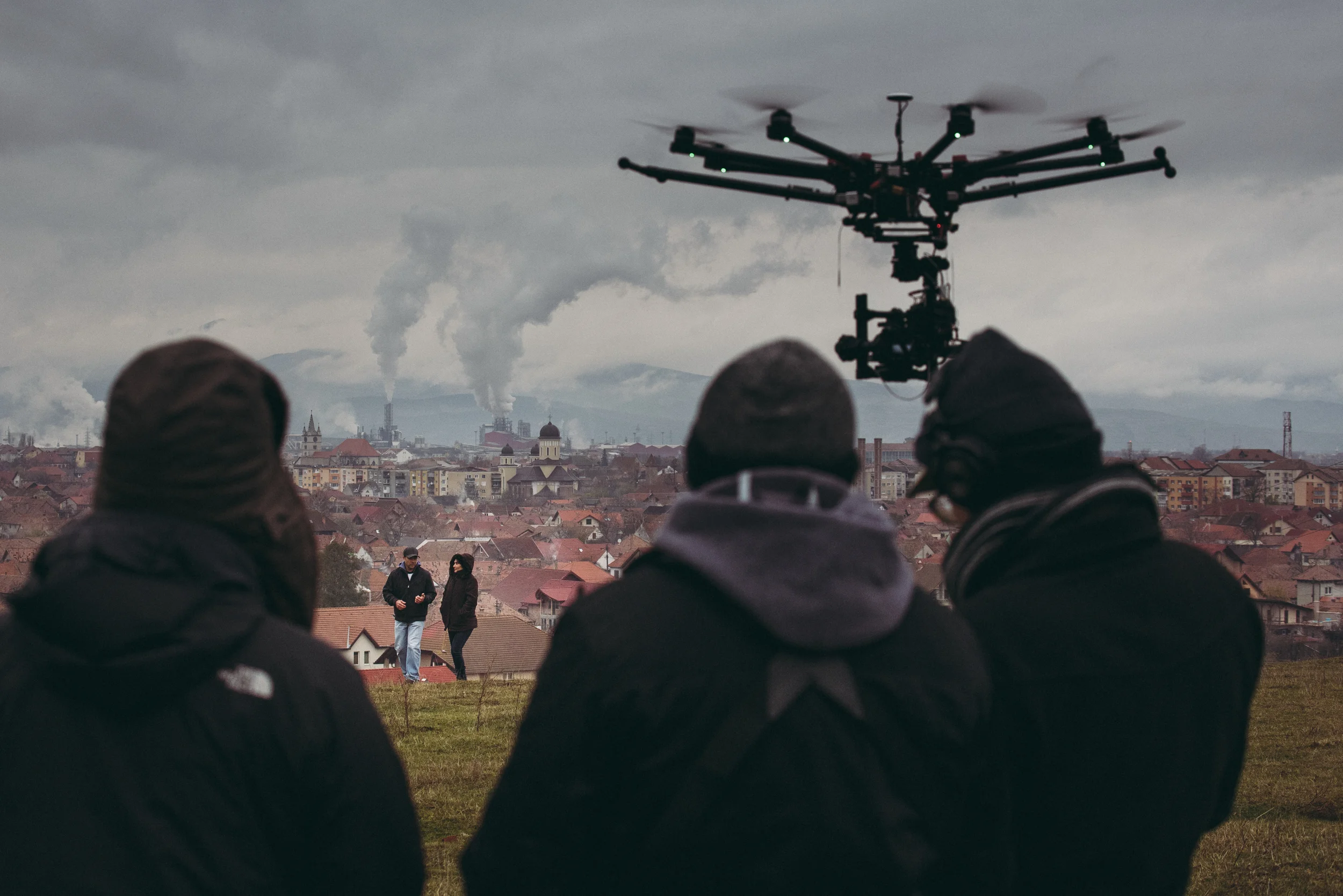 POP-UP 2: Shooting in the heart of Transylvania, Romania overlooking the town called Sebes. A factory which processes wood blows huge plumes across the horizon. We filmed with a drone during several scenes in Romania. (Photo by Dan Pereț)