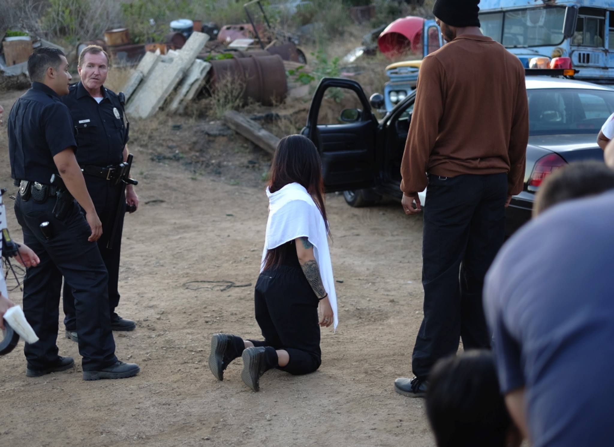 Behind the scenes- The director is putting herself on the ground to find the mark for the actor instead of letting him lie on the dirt.